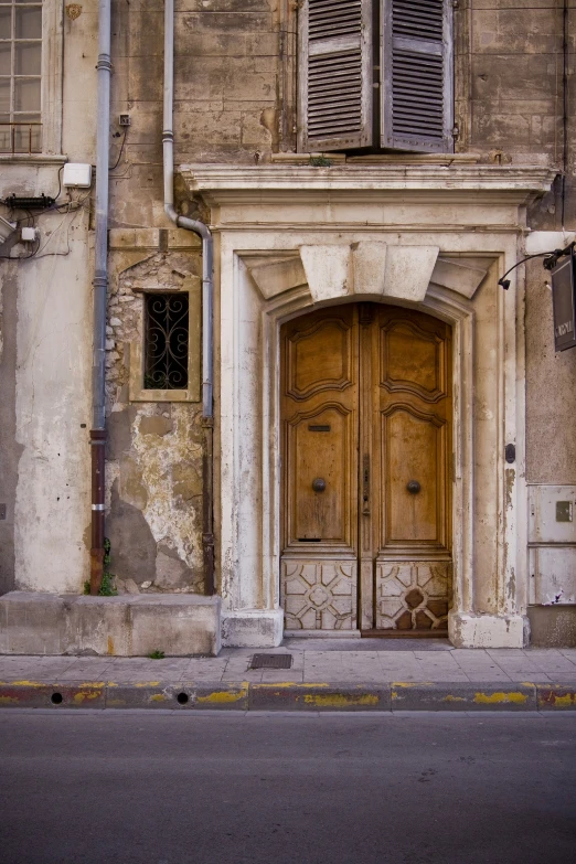 two open doors are shown on a old building