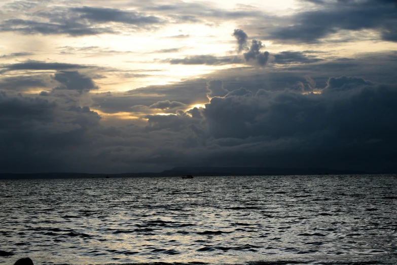 a dark cloudy sky over a large body of water