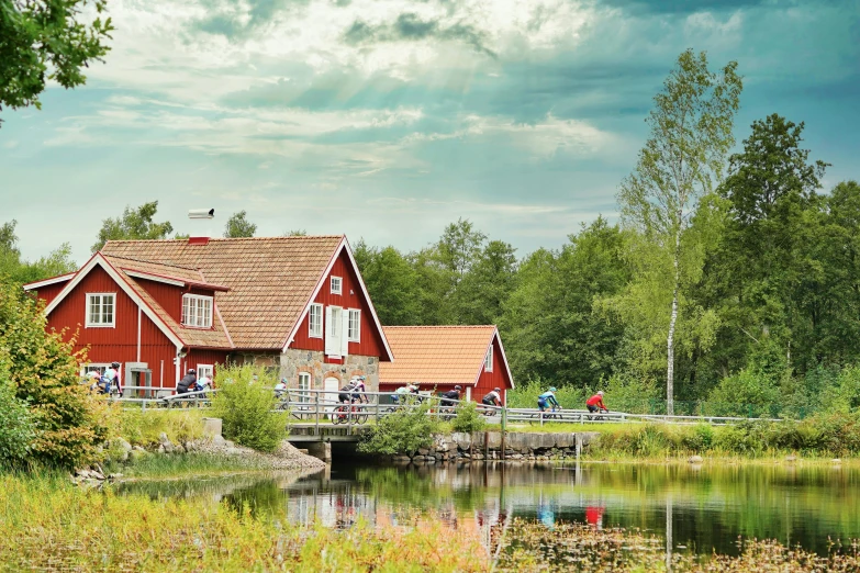 the wooden house has red shingled roof and windows