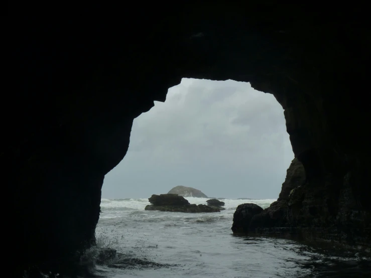 an open cave with water coming out of it