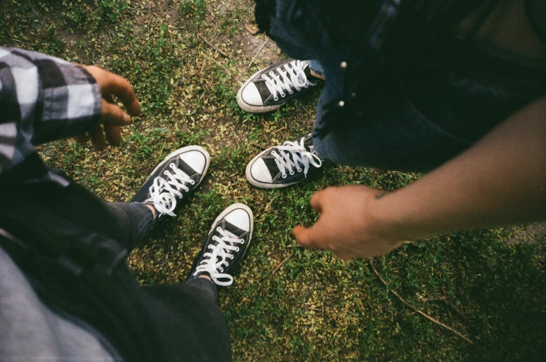 three young men who are wearing tennis shoes