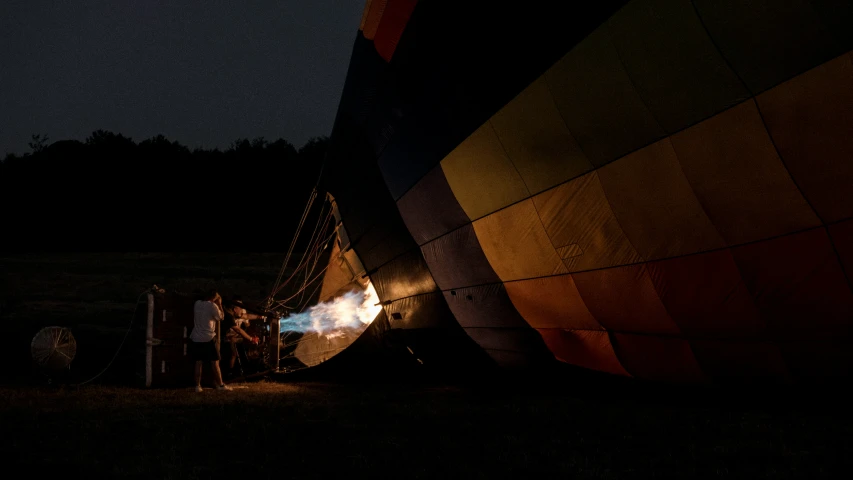 two people standing under a large balloon