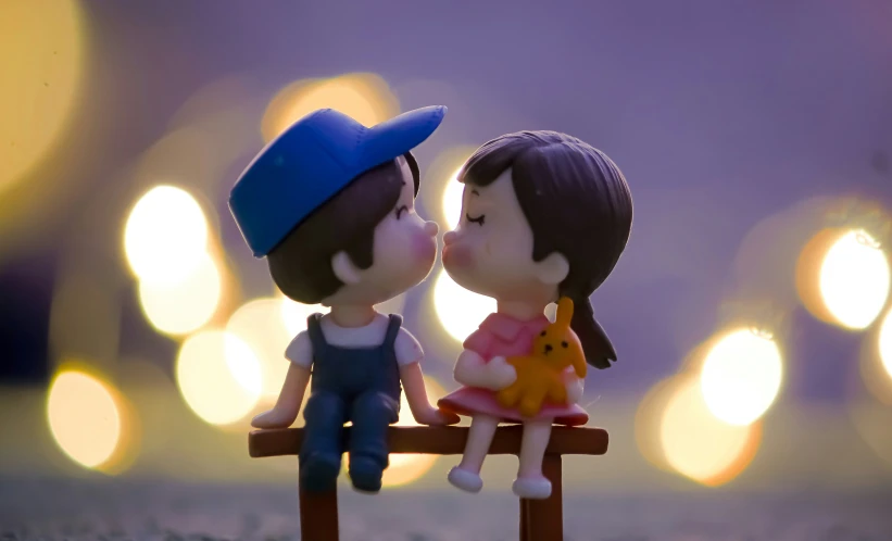 an adorable little girl kissing a boy on a bench