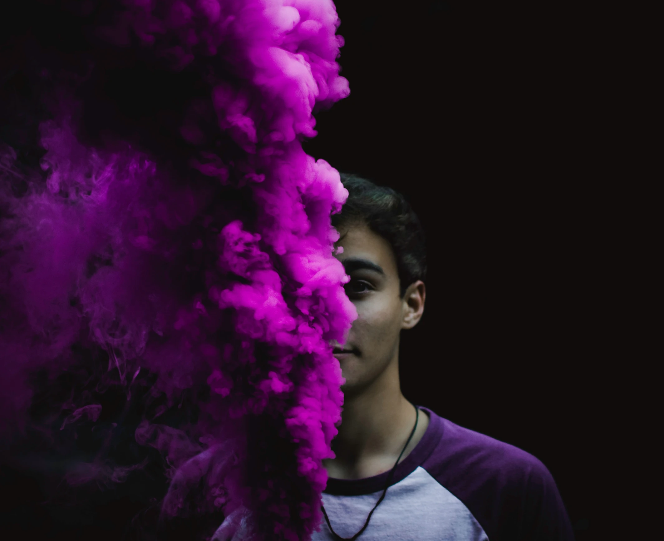 a man looking up with smoke billowing out of his face