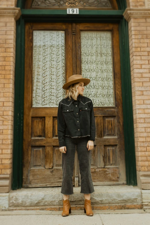 a woman in jeans and a cowboy hat
