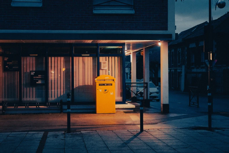 a yellow pay meter on the side of a street