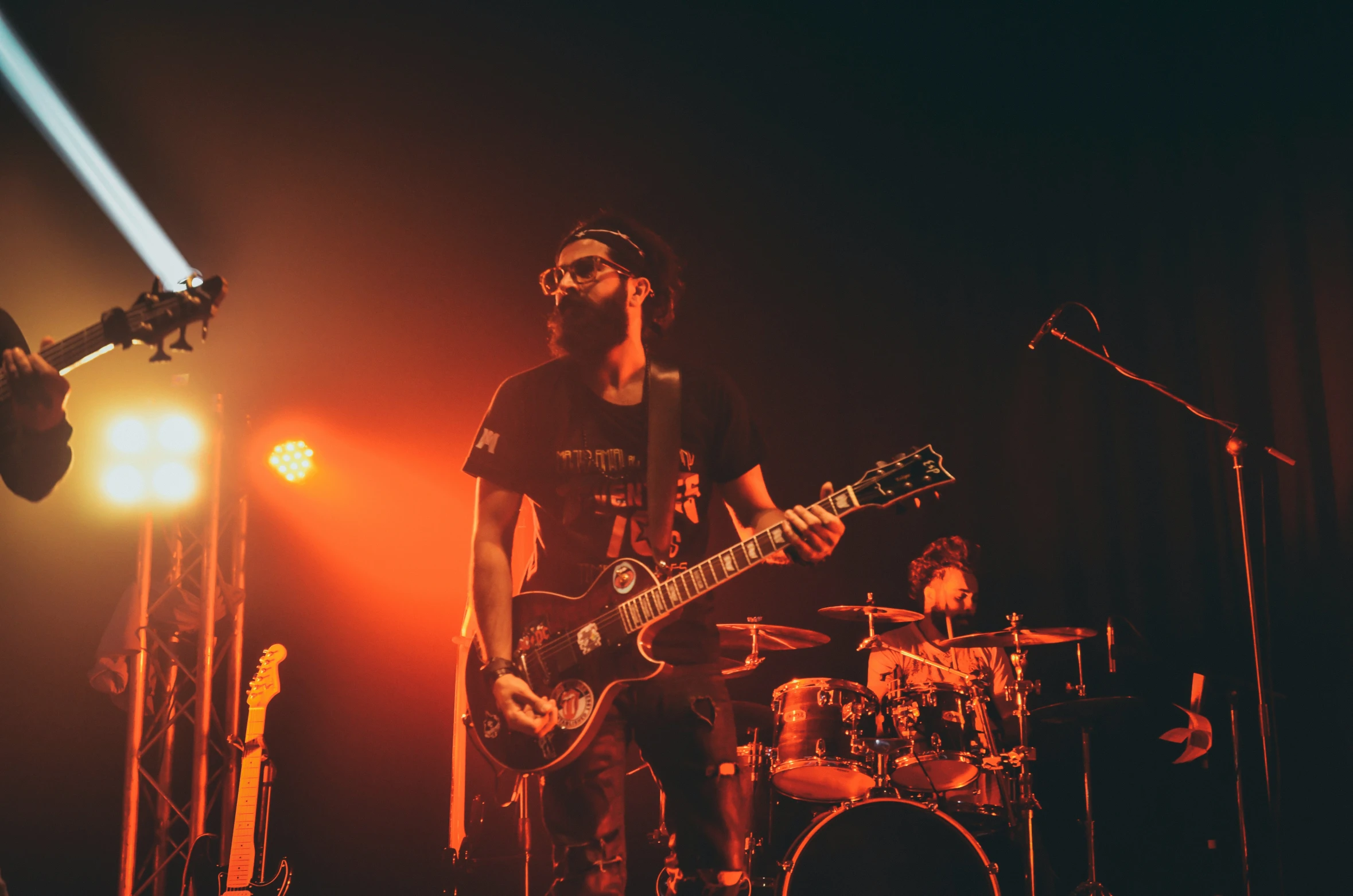 a group of young men playing guitar on stage