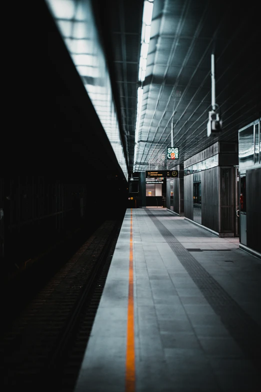 an empty train station with the train stopped on one side