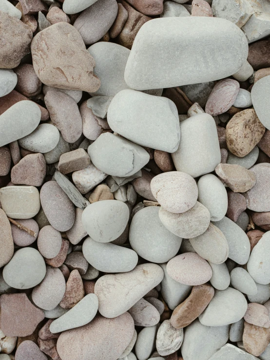 small stones on a pile with grass in background