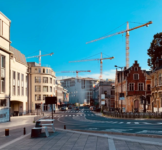 a street with traffic and some building construction in the background