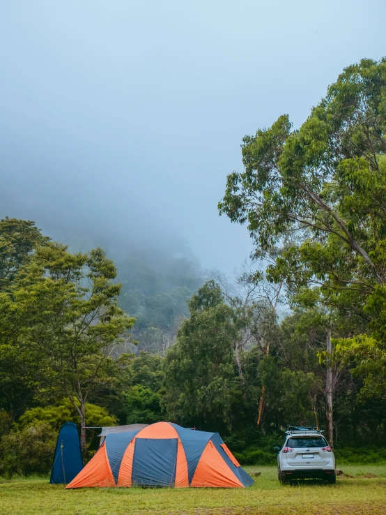 a tent and a car are in the foreground