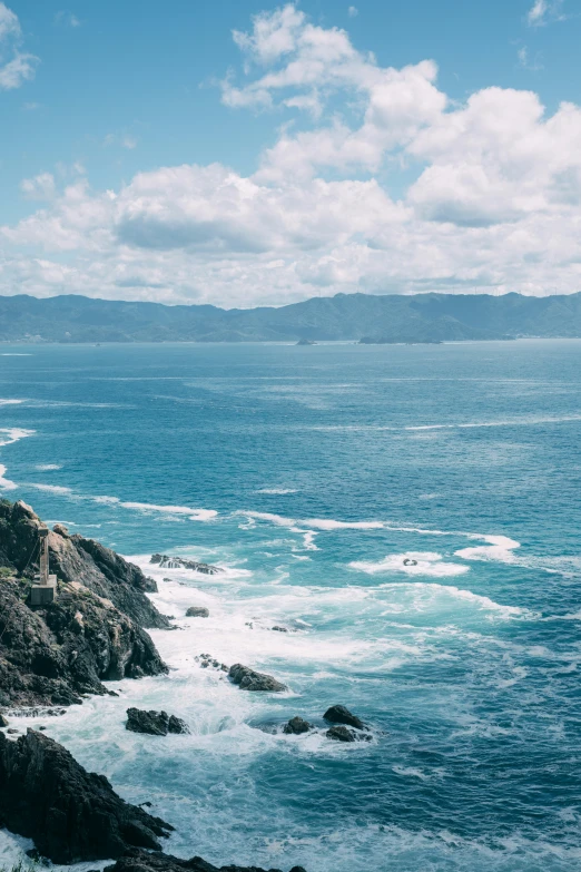 the lighthouse sits alone on the rocks overlooking the ocean