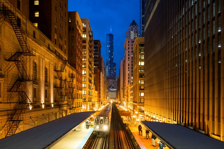 a train is traveling through a city with tall buildings