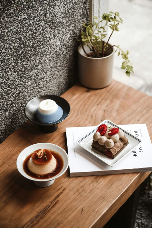 a table with a wooden surface with a cup of coffee and pastry on it