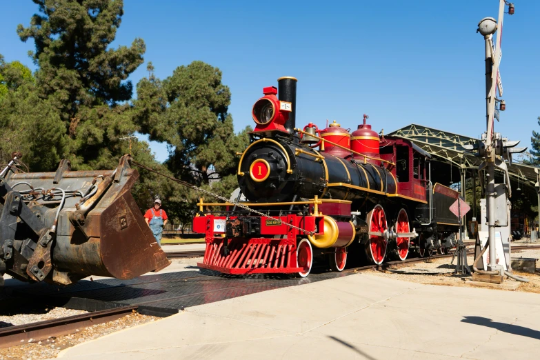 an old train engine with a yellow caboose