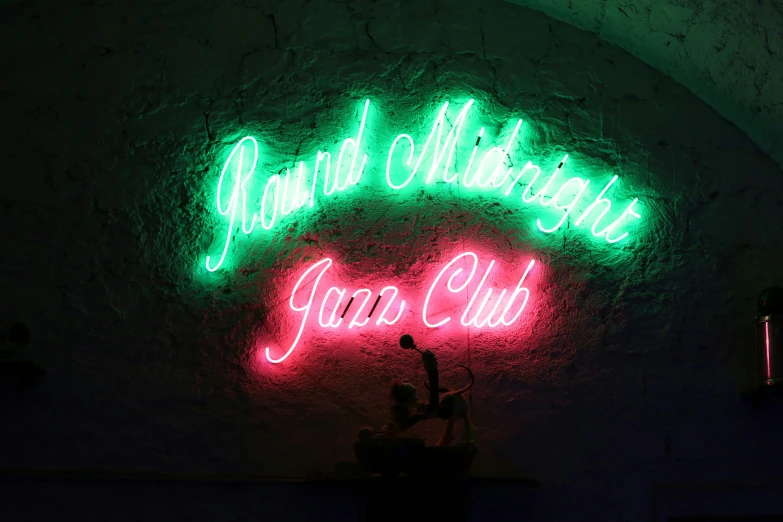 a neon sign is lit up on the wall