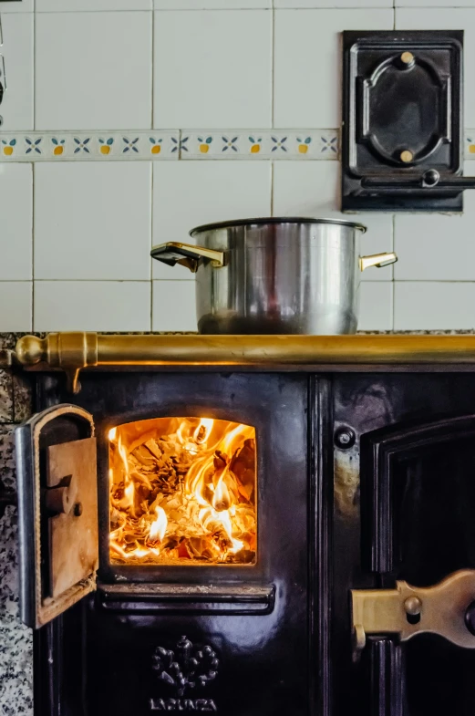 a stove top with the door open and burning