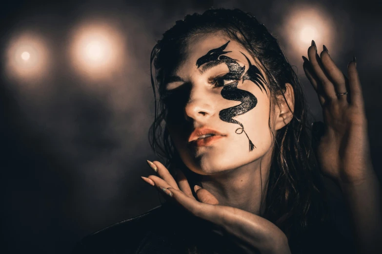 woman wearing face paint with snake skin and lipstick