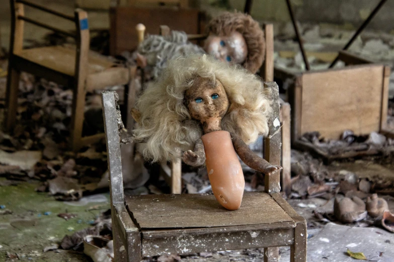 an old rocking chair with a teddy bear holding a huge, burnt, brown item