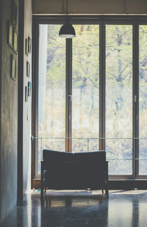 a couch is in front of a large window