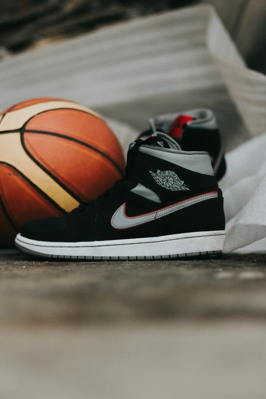 black and white sneakers on a basketball and sheet