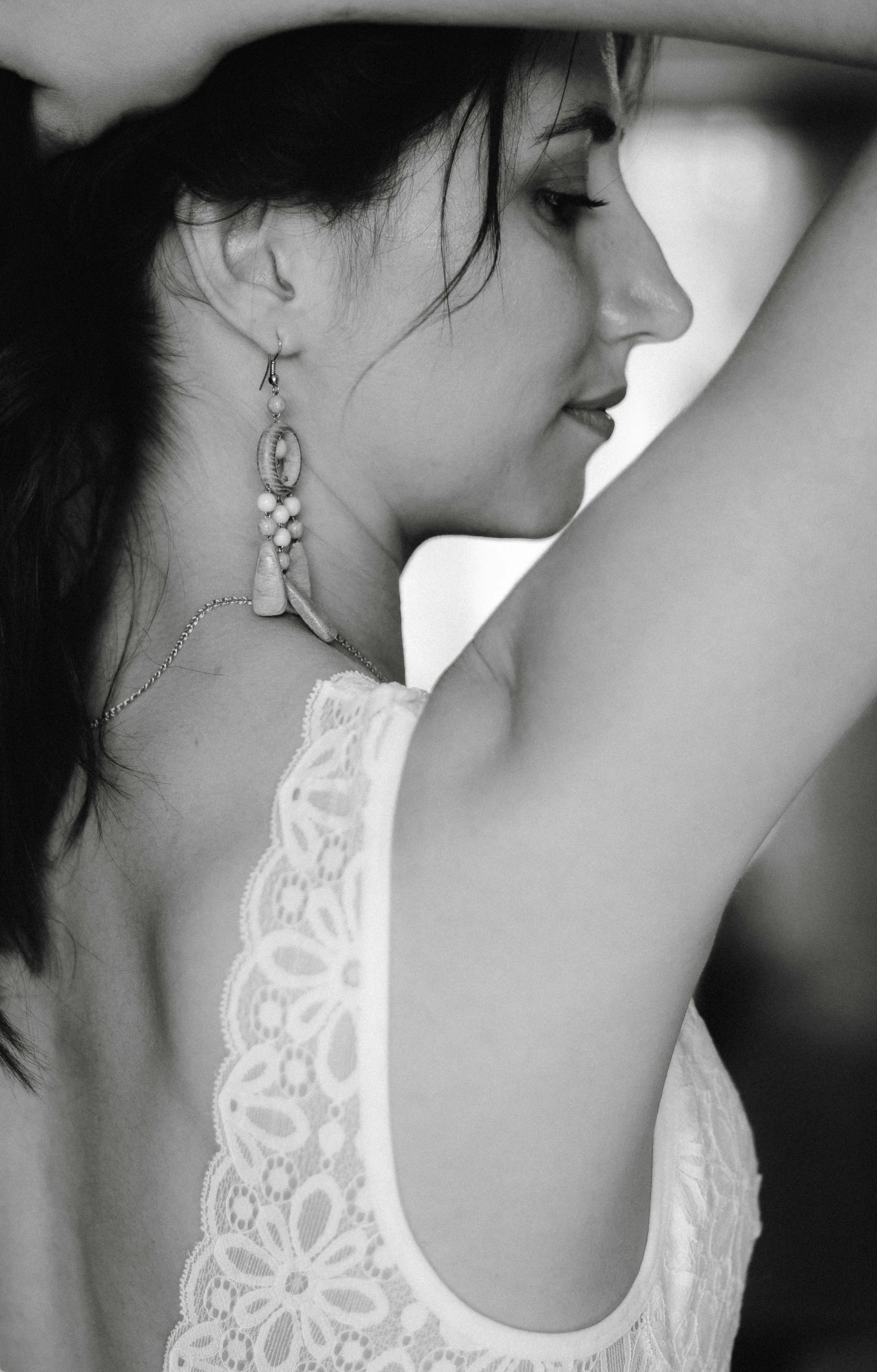 black and white pograph of woman in white lacy dress