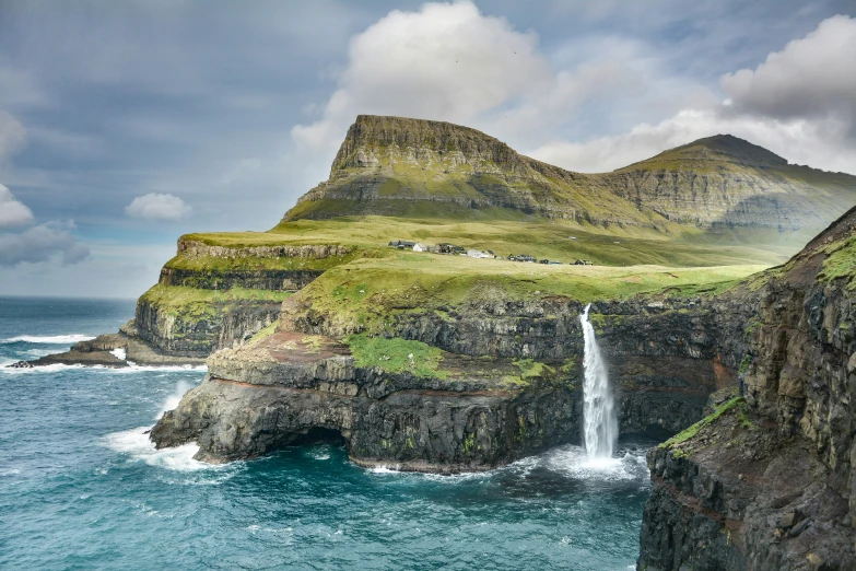 a waterfall in the middle of the ocean