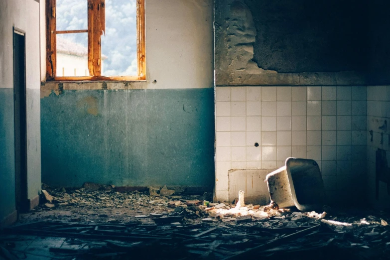 an old bathroom filled with junk and broken up tiles