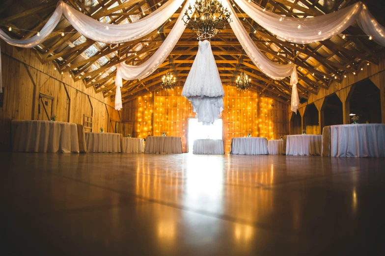 a barn with lights that are glowing on the ceiling