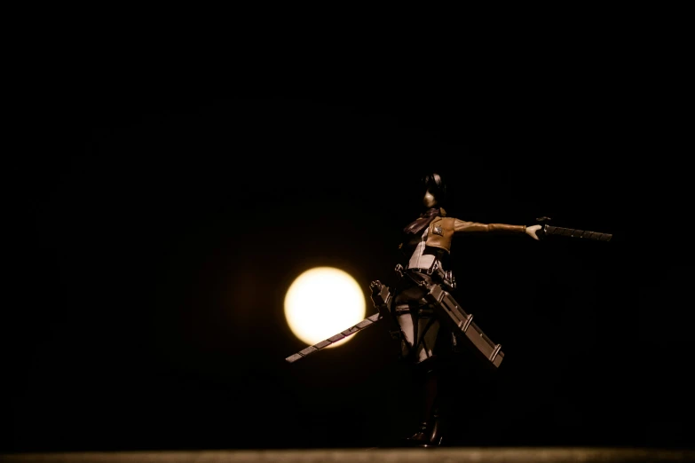 a toy doll holding two umbrellas in front of the moon