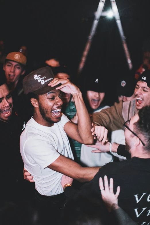 a man in a crowd of people reaching towards him