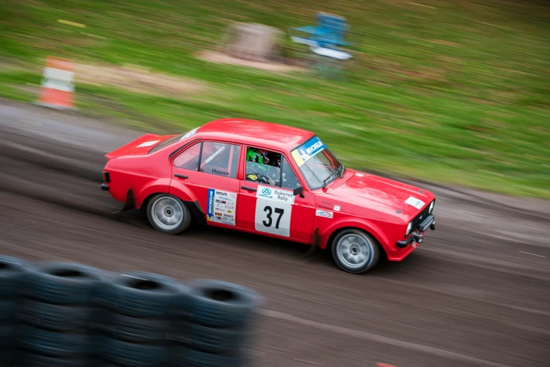 a car drives in a race with tires around it