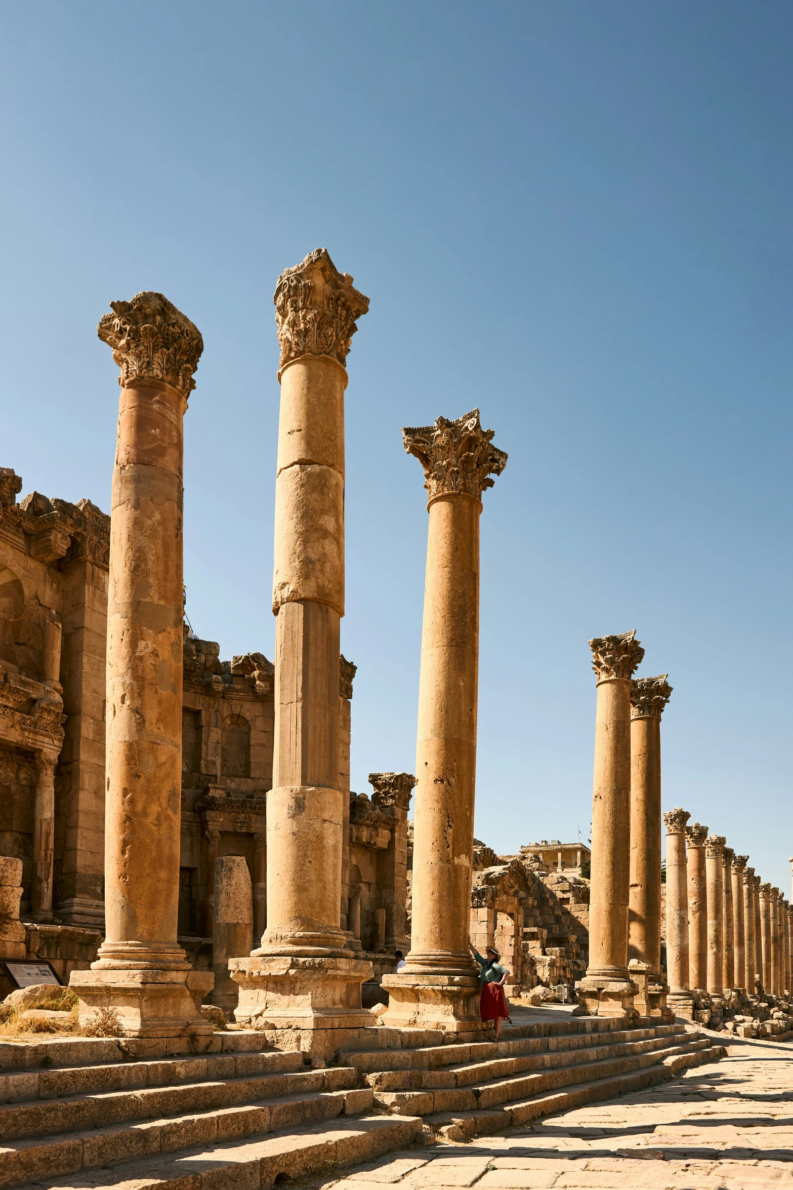 many stone columns line the street near ruins