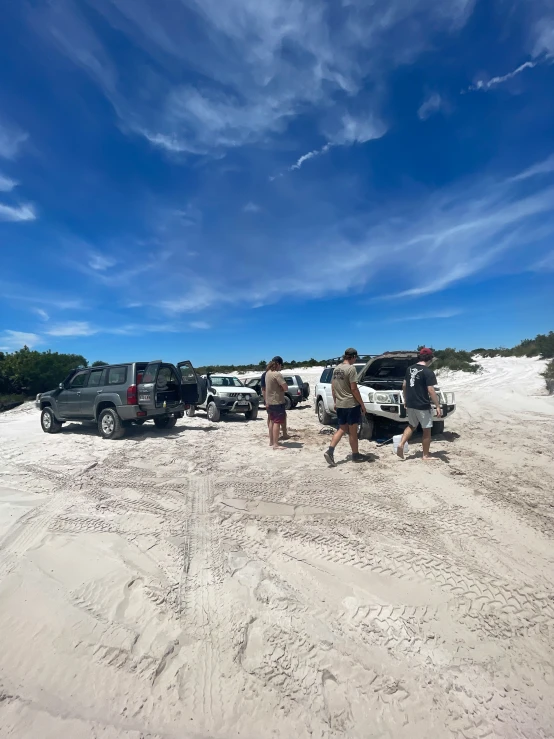 the vehicles are lined up in the sand on the beach