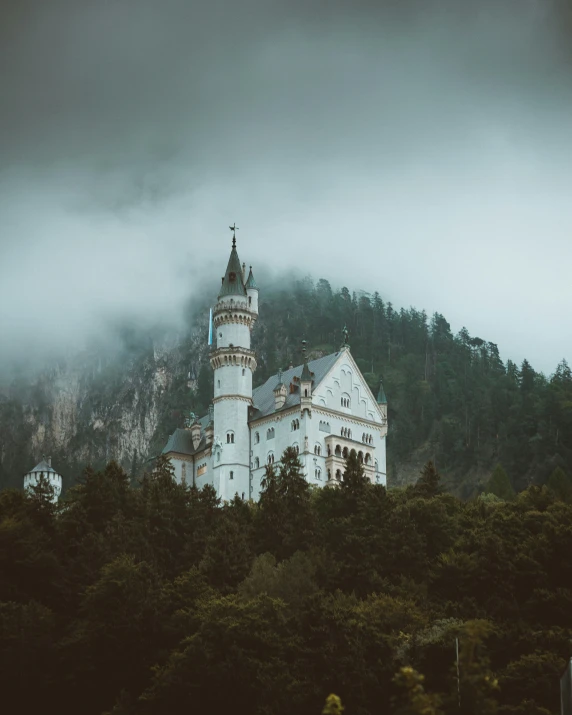 a white castle sitting on top of a lush green hillside