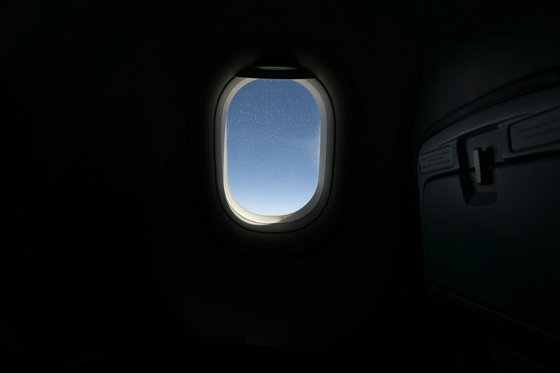 the view of a plane window looking out to the sky