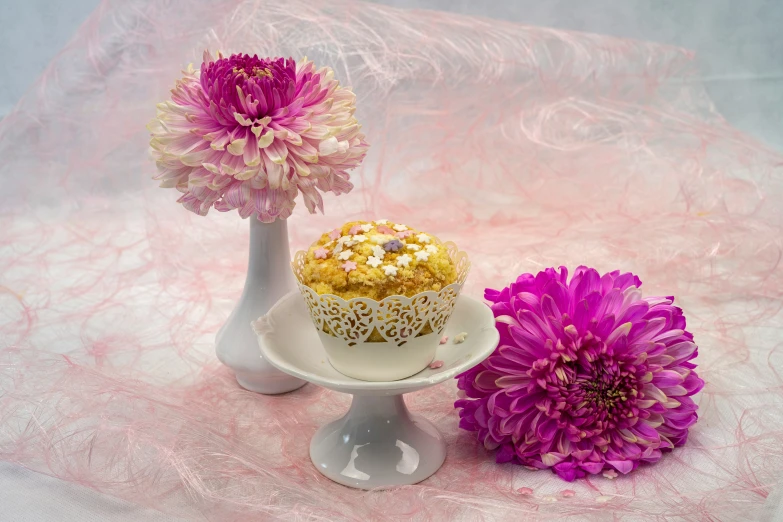 cupcake and flower on display on a table