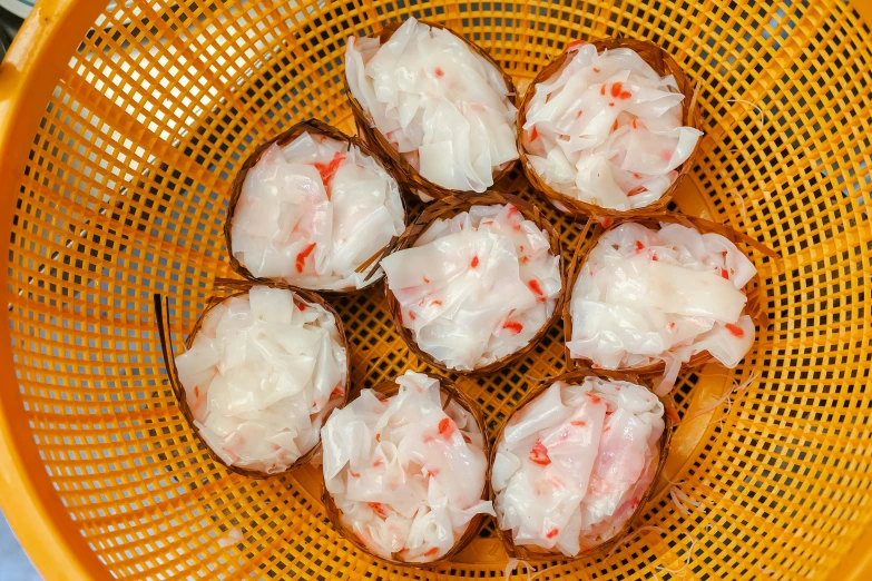 several pieces of food sit inside of a yellow basket