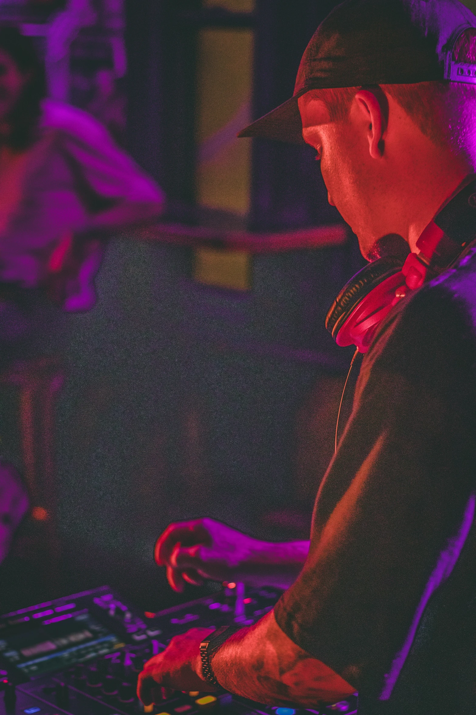 dj playing in front of a microphone with headphones on