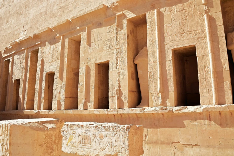 a row of stone columns sitting next to a wall