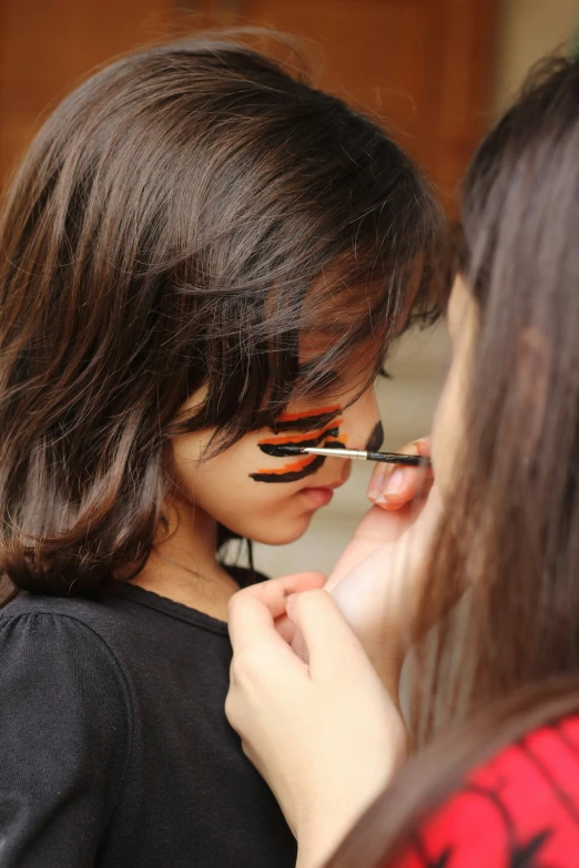 a young woman with makeup applied to her face