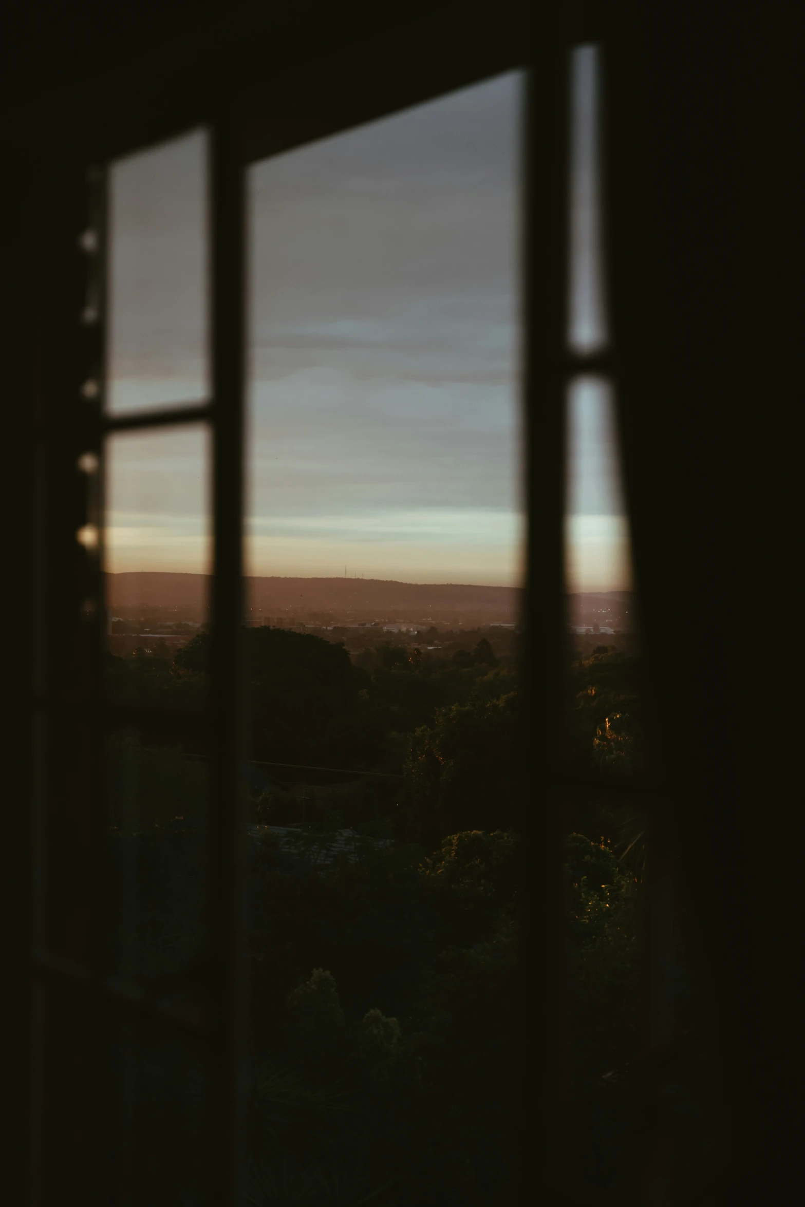 view from inside of open window at dusk