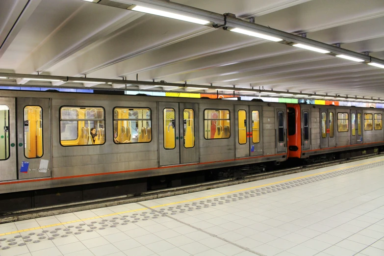 a subway train parked at the station to pick up passengers