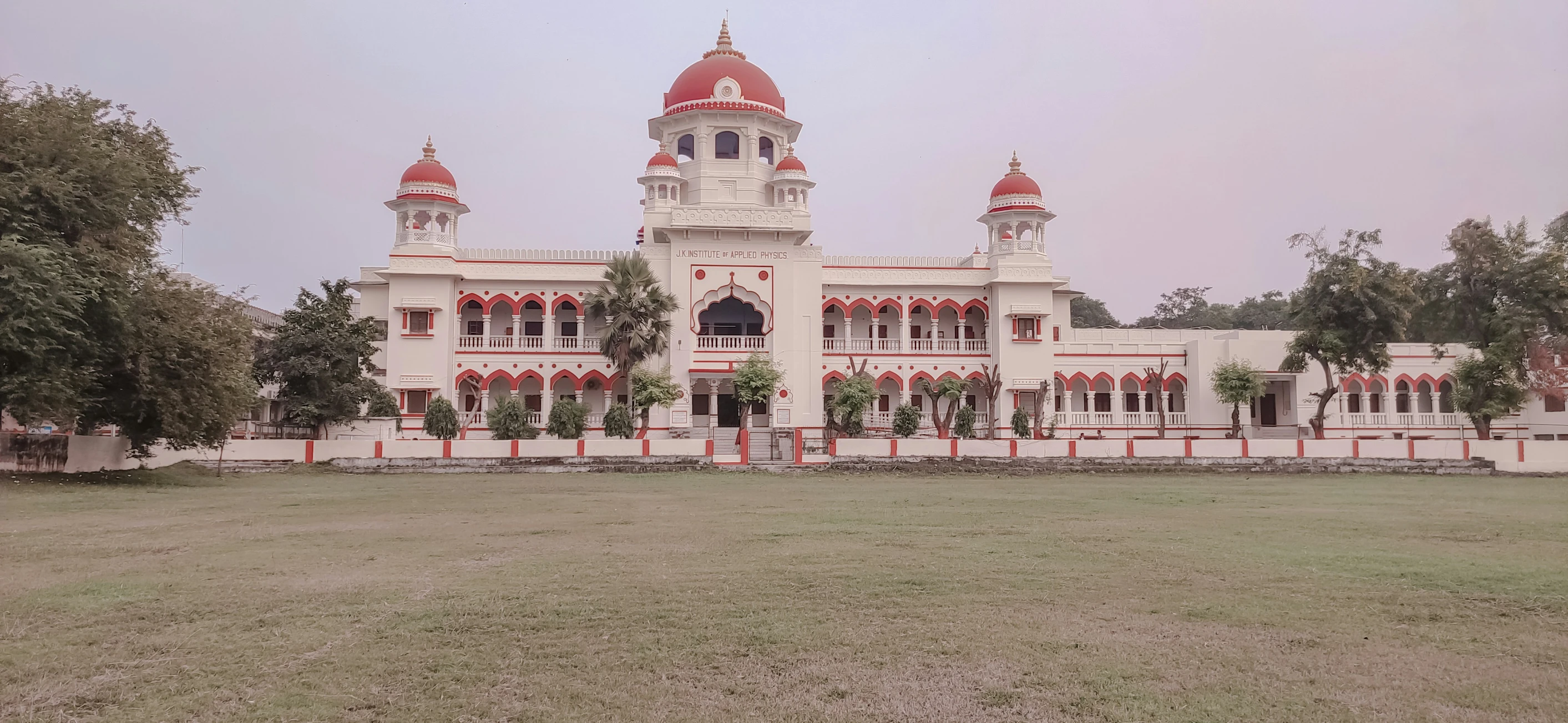 an old building has red and white trim