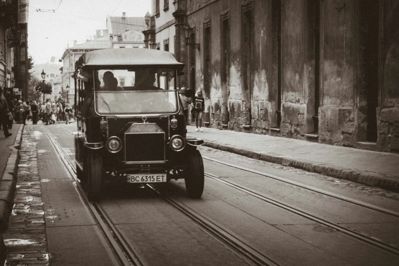 a car riding down the street in an old town