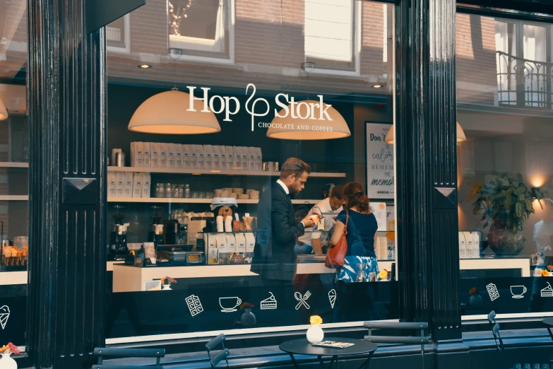 a couple of people are standing outside a shop