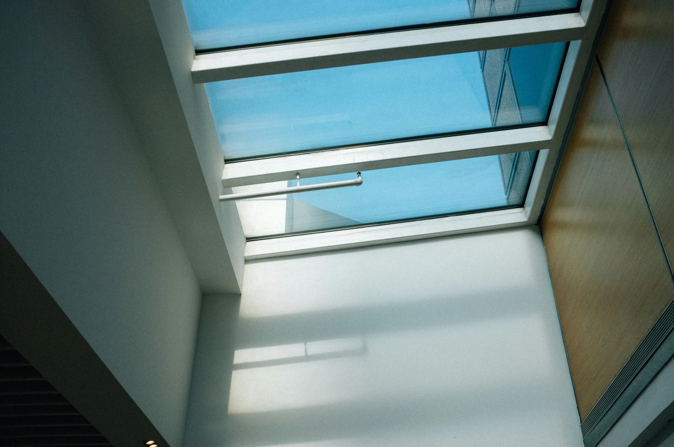 a long building with glass windows and skylight