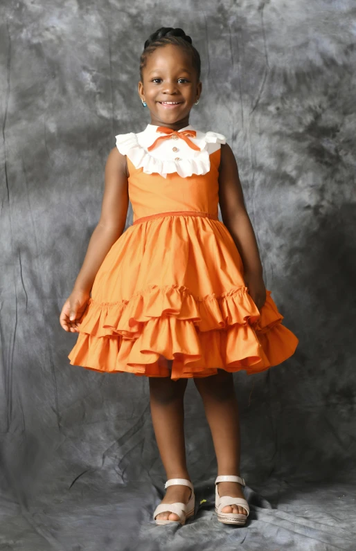 a child wearing a bright orange dress