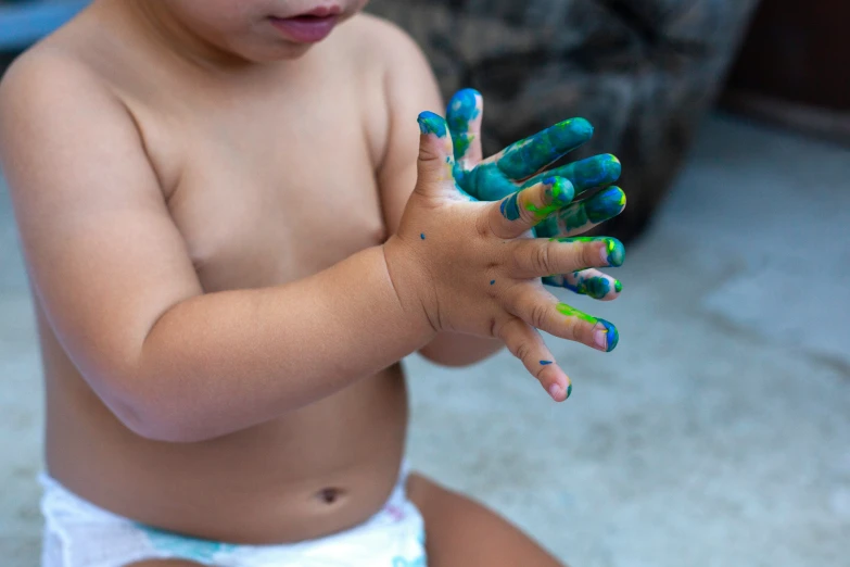 there is a baby that has painted hands