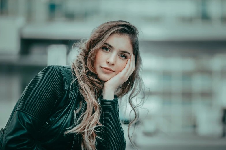 a girl with long, wavy hair looks away while leaning on the railing